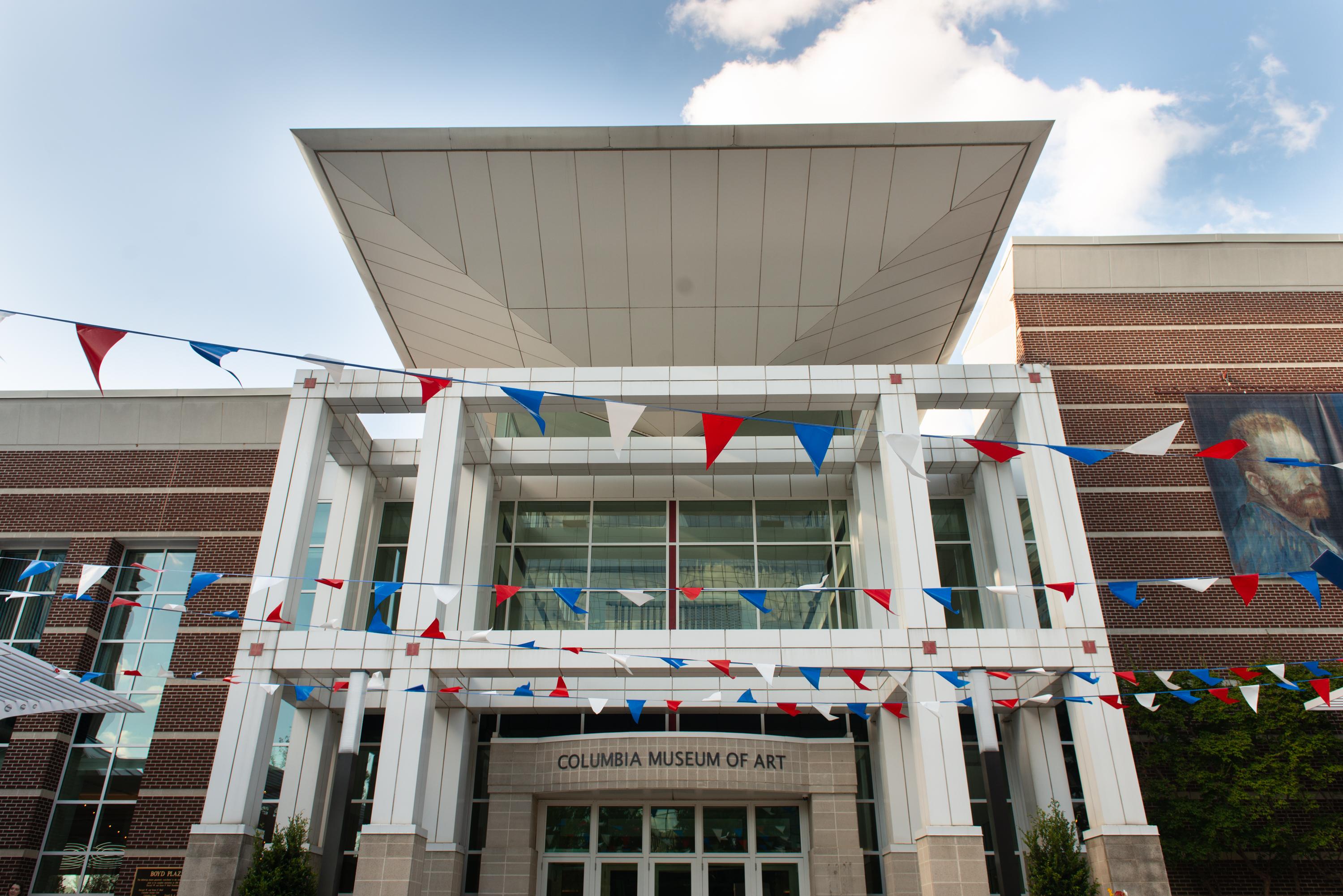 The Columbia Museum of Art building with festive flags hung in front