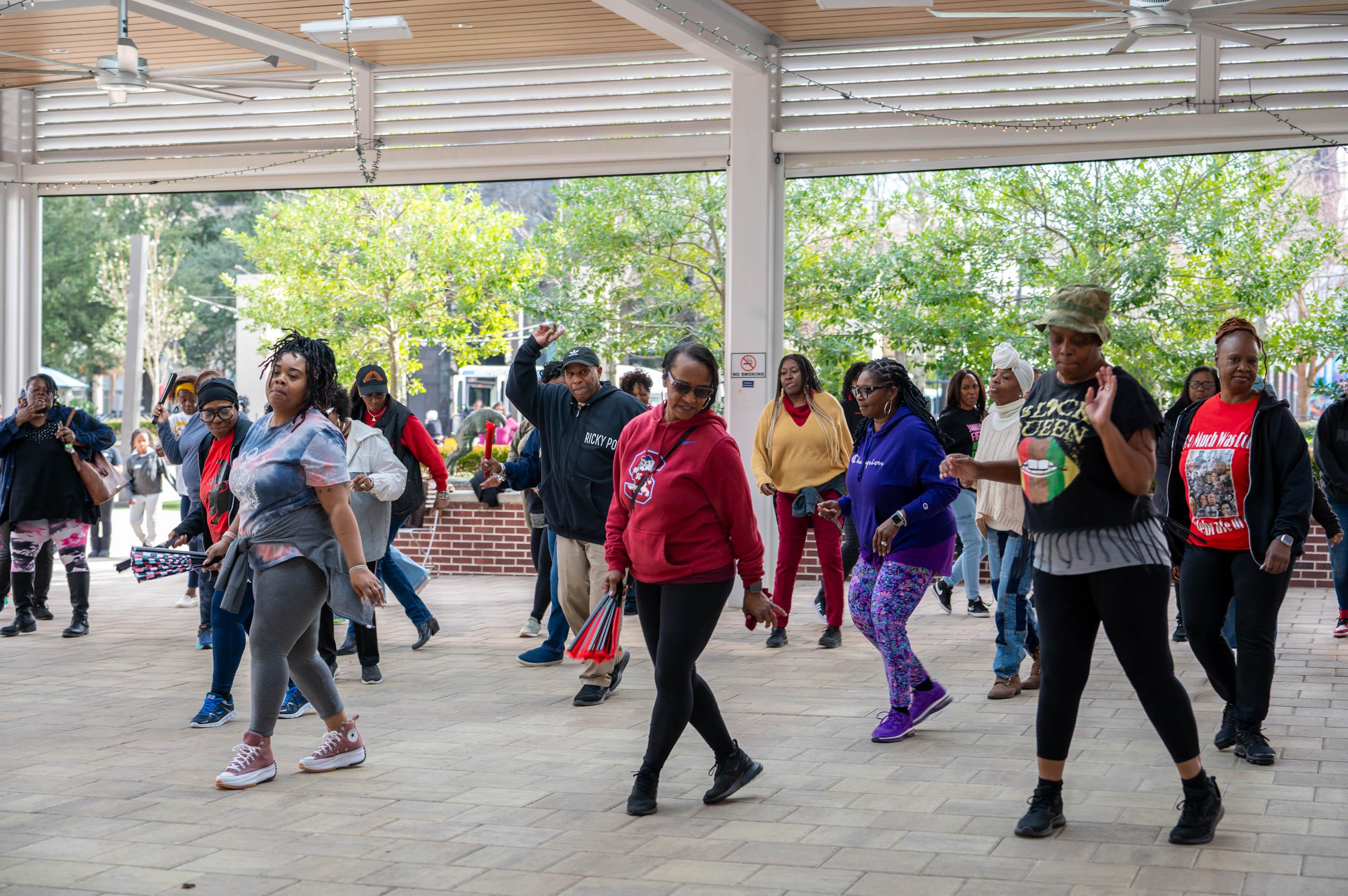 visitors line dancing on Boyd Plaza