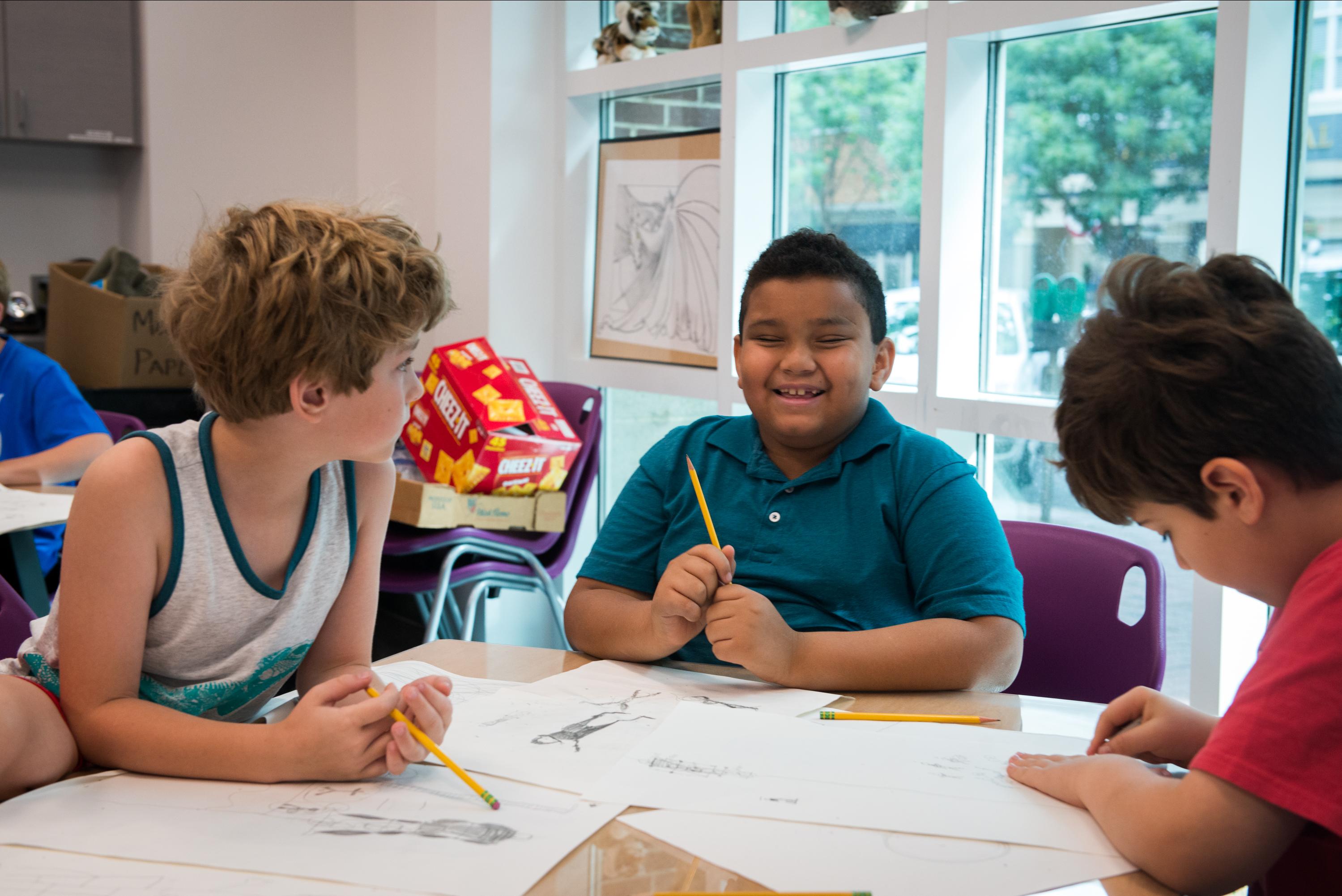 children drawing together in the studios