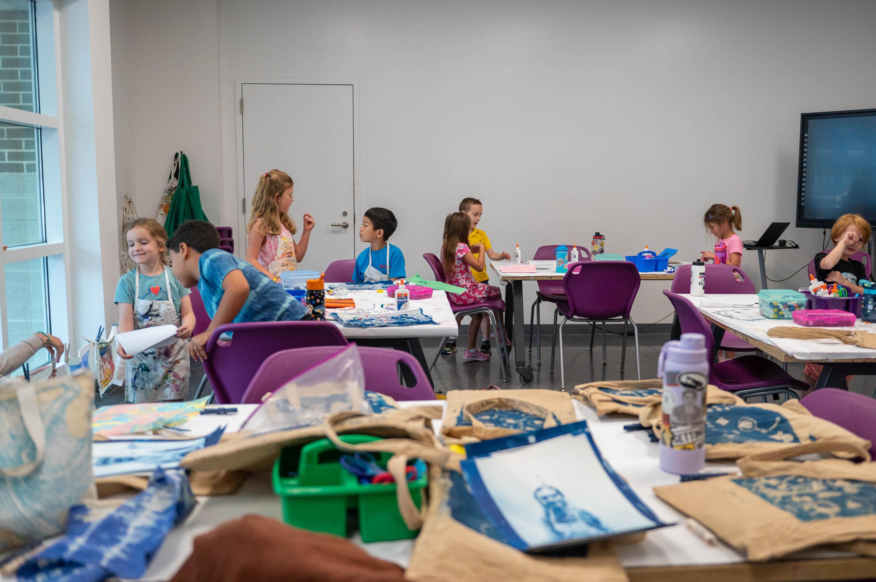 Summer campers working on fabric art