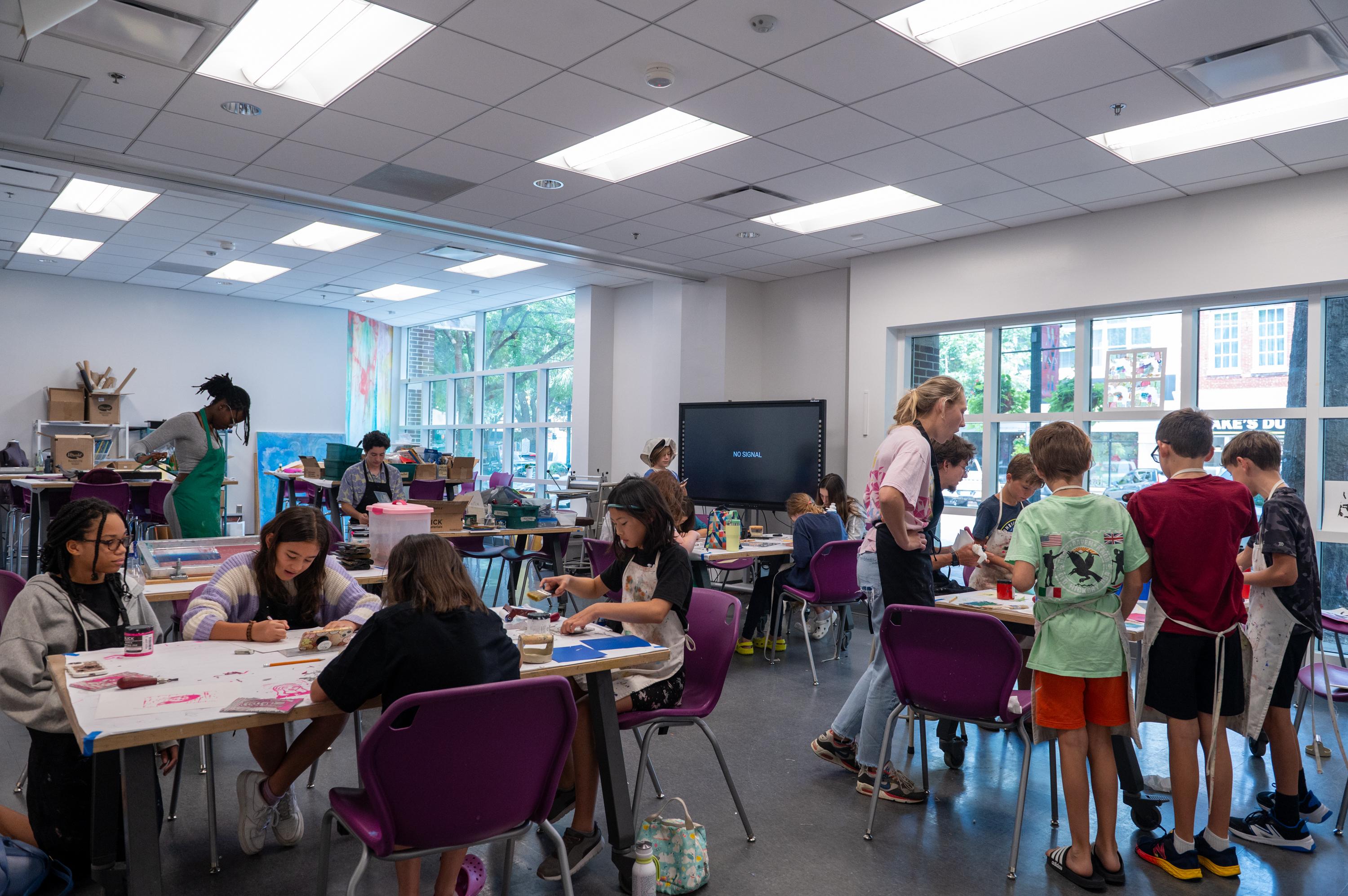 a studio full of kids making prints